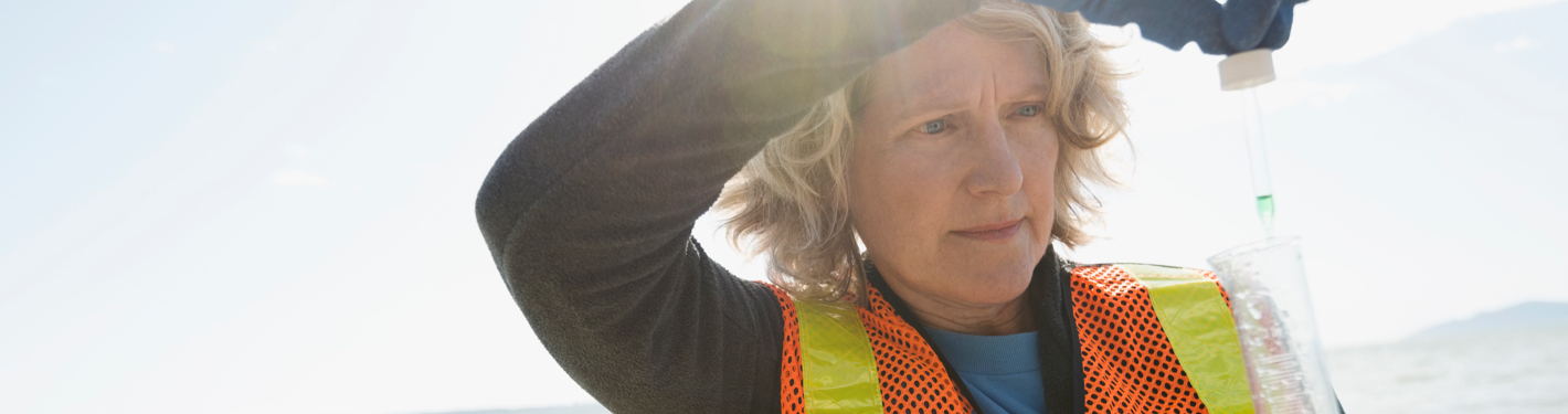 A scientist analyses a water sample collected from the sea