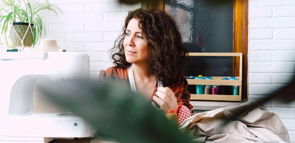 A woman at home sewing