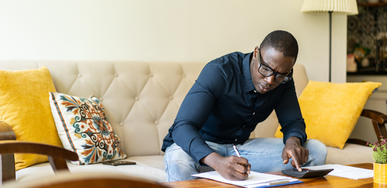 Man writing on coffee table