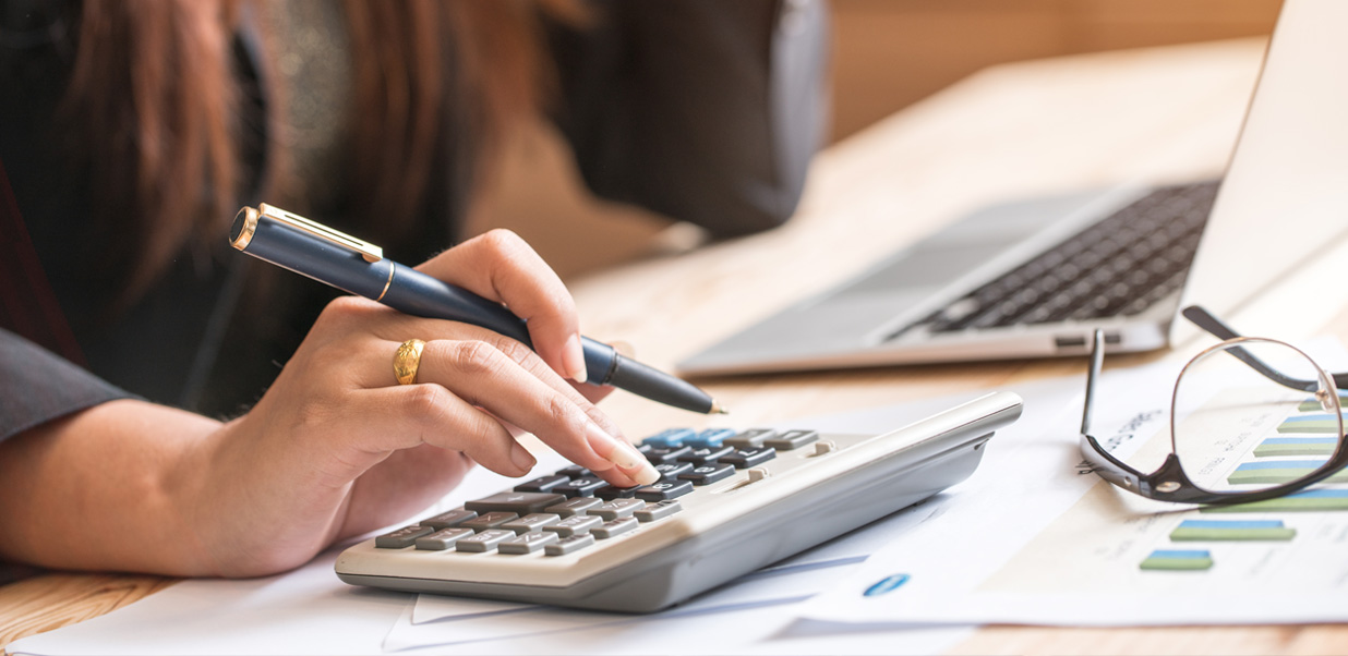 Image of a woman using a calculator