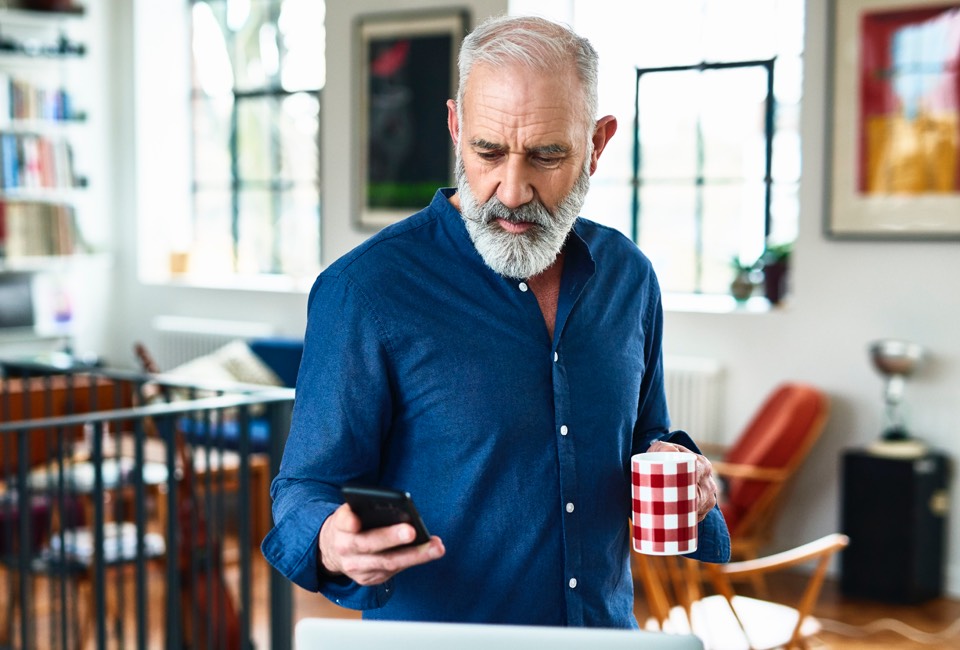 older man looking at his phone