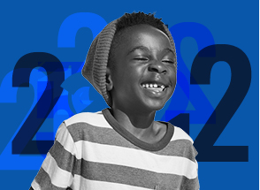Child smiling with number 2 graphical background