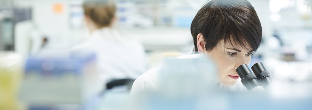 Image of a scientist inspecting samples in a lab