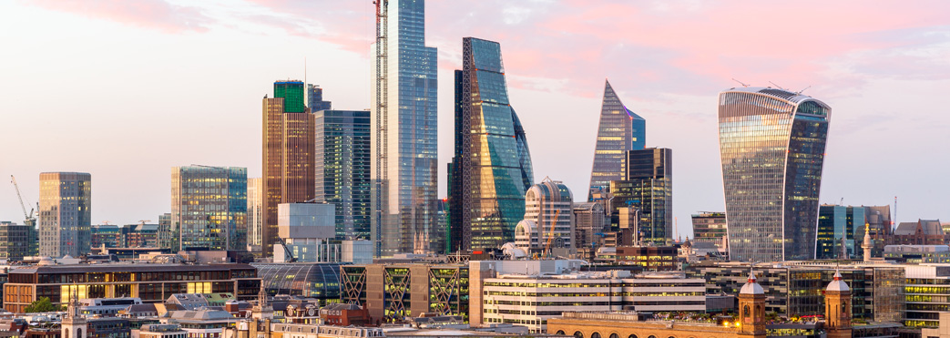 Image of a sunset skyline across skyscraper buildings in Canary Wharf in London